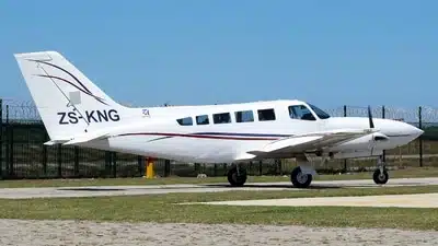 KZN Aviation's Cessna 402 aircraft ZS-KNG with 2 piston engines, 6-passenger capacity, and 1500km range parked at airport.