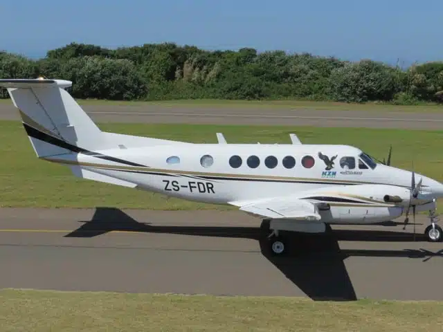 KZN Aviation's FDR KingAir aircraft ZS-FDR with gas turbine engines, 8-passenger capacity, and 2300km range parked on airstrip.